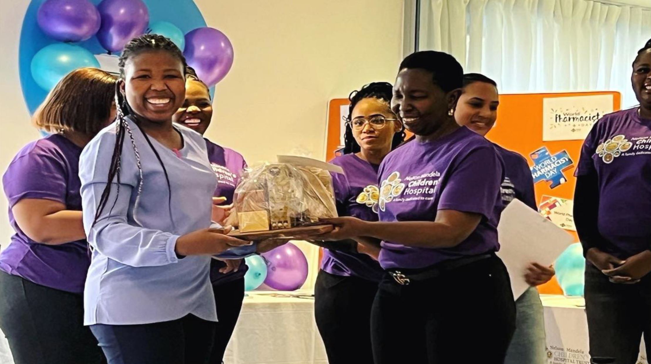 Isabella Mphuthi handing over the prize to quiz winner Annah Leshaba
