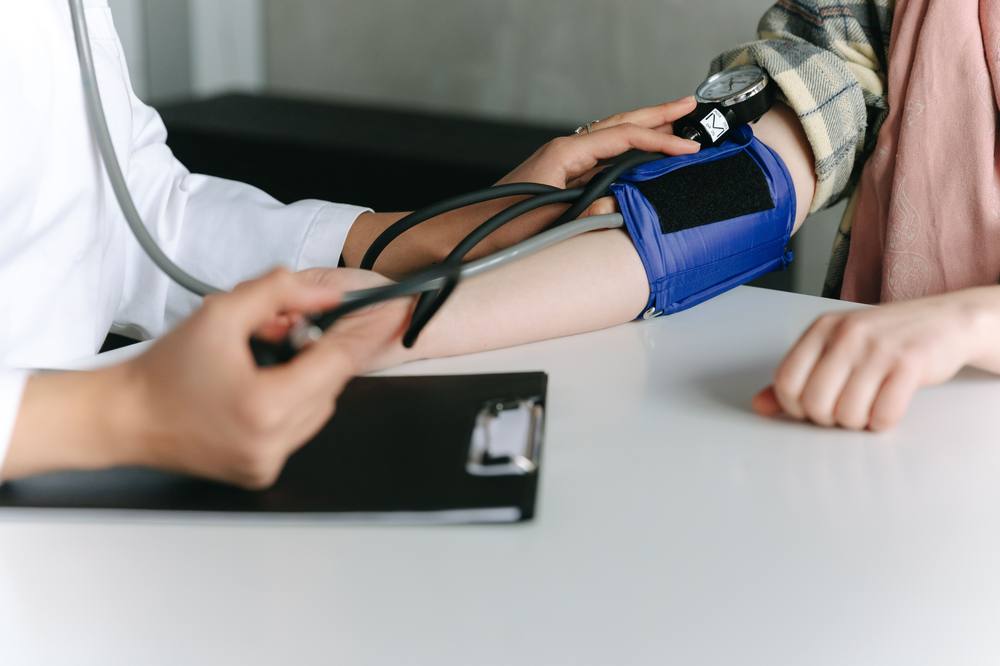 A pharmacist conducting a routine blood pressure check