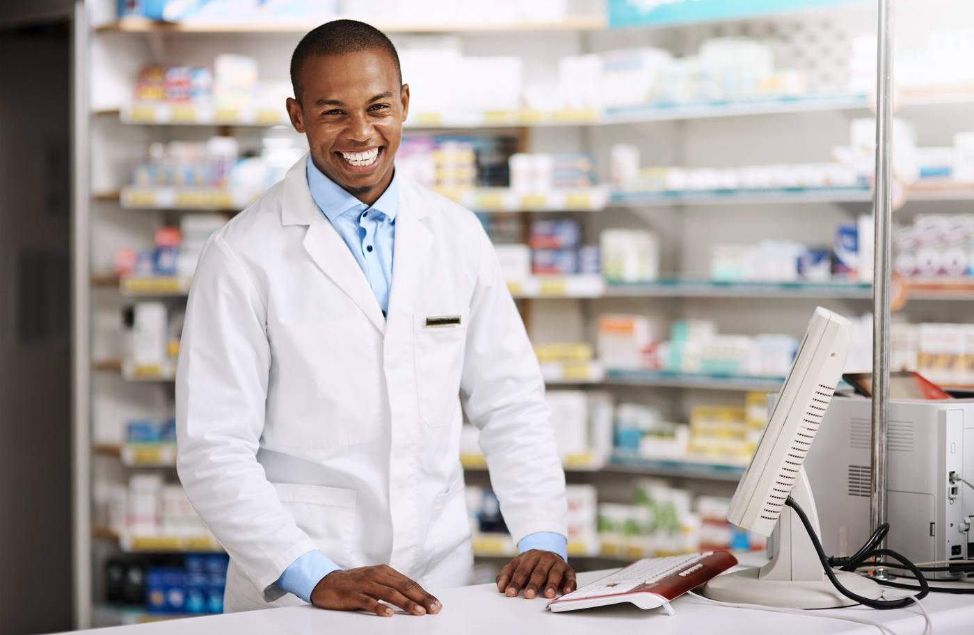 A pharmacist assisting a patient at the pharmacy checkout