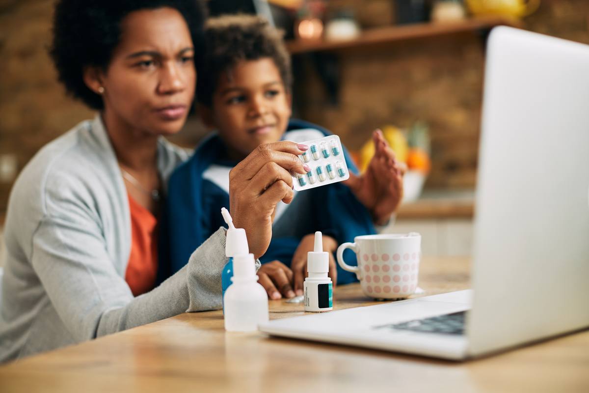 A mother and her son reviewing medication information at home